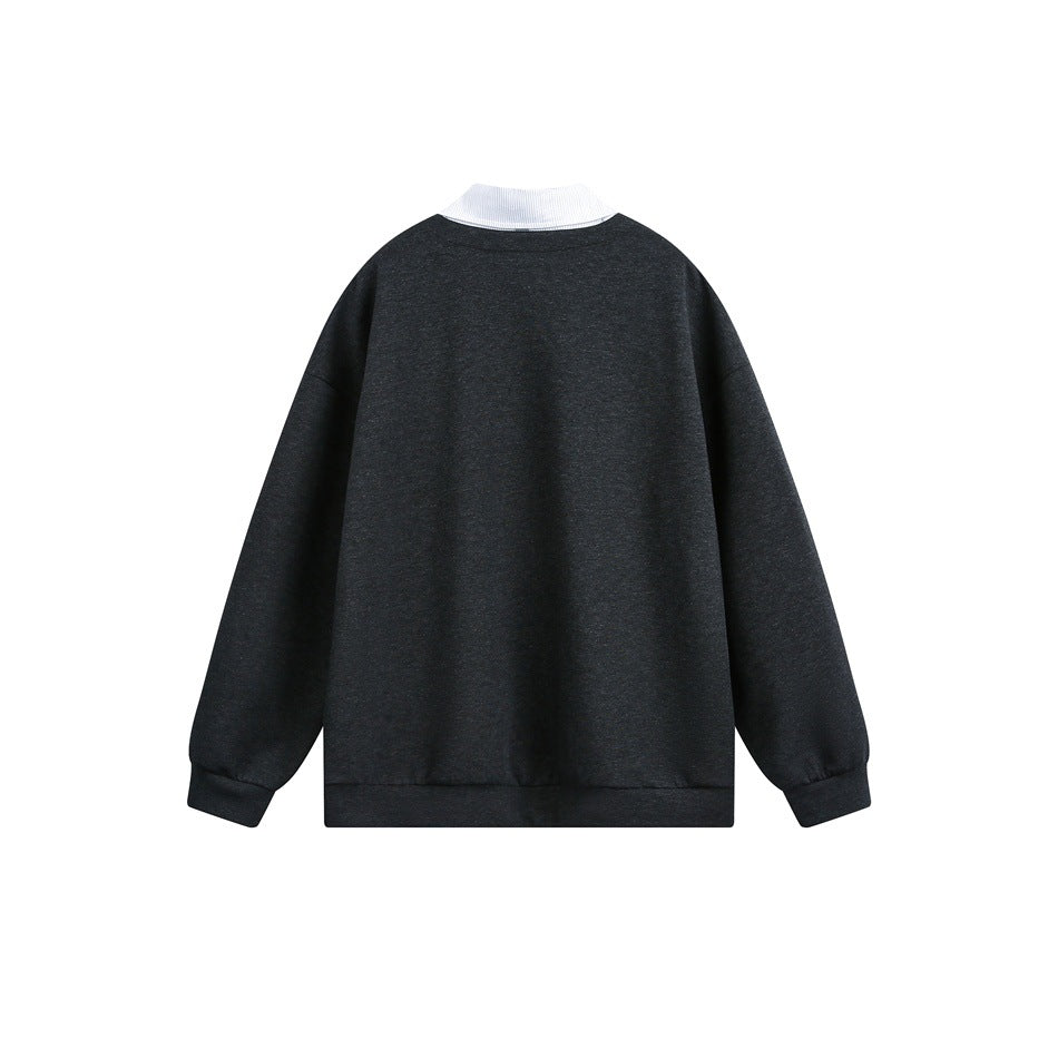Back of a dark charcoal pullover with a white collar visible above the neckline.