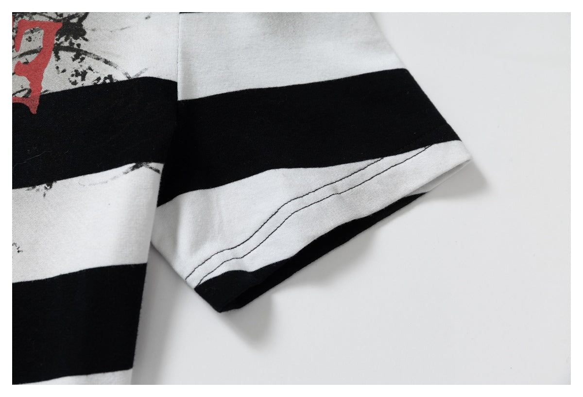 Close-up of a striped sleeve and stitched hem, with part of the distressed print visible.