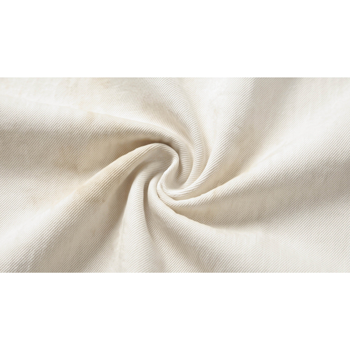 Macro view of ivory twill fabric gathered into soft folds.