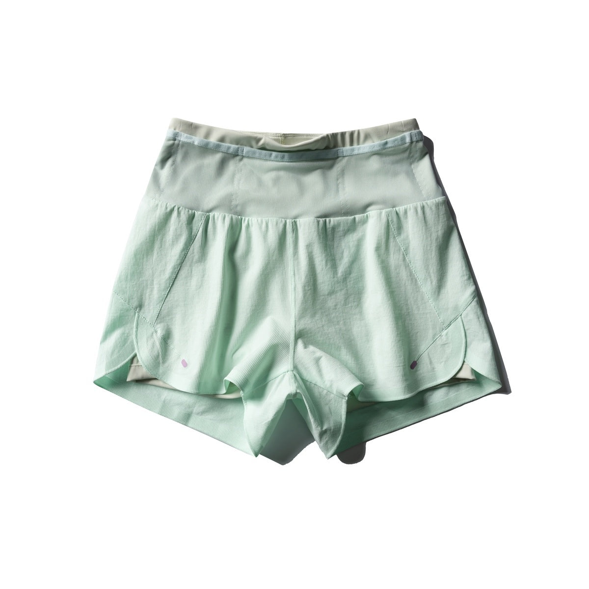 Light aqua green double-layer athletic shorts, flat lay front view with high waist panel and scalloped hems