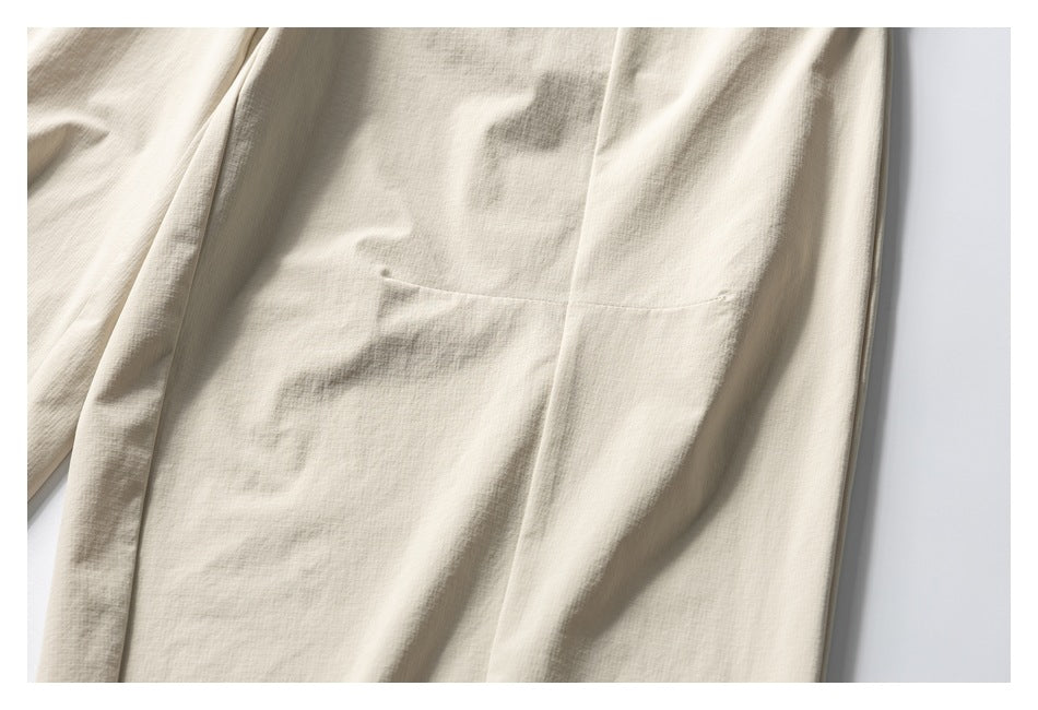 Close-up of the light beige trouser leg with a visible seam and pocket edge.