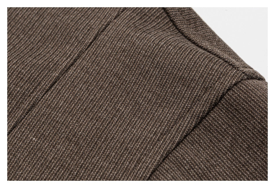 Close-up showing stitching and panel seams on brown textured fabric.