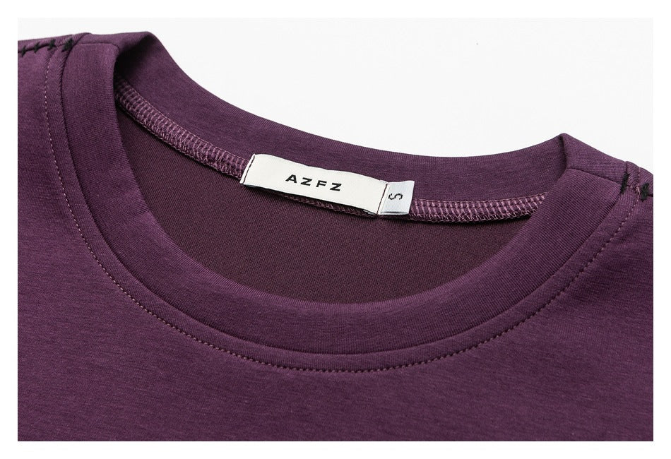 Close-up of the plum shirt's crew neckline, stitching, and neck label.