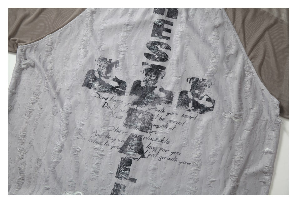 Close view of a white garment front with distressed black lettering and raised wavy vertical stripes.