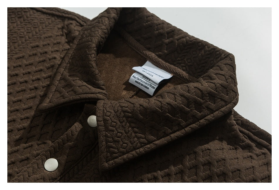 Close-up of the brown jacket's collar, white snap buttons, and interior label reading Made in China.