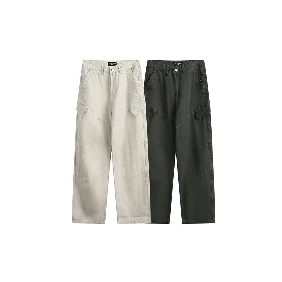 Front view of wide-leg cargo pants in light beige and dark charcoal, with angled pockets and flap details.