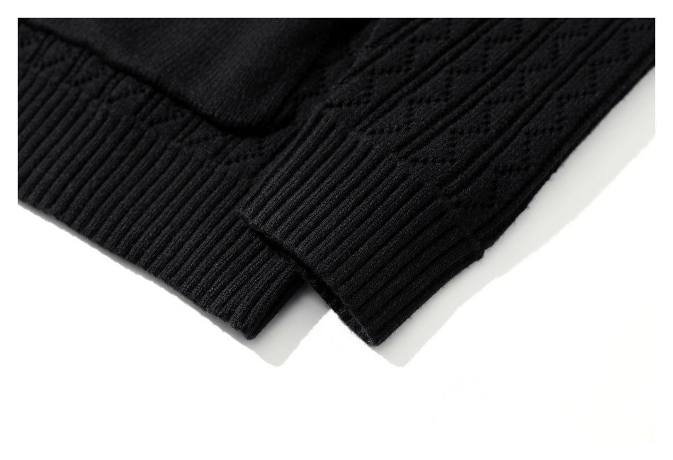 Close-up of black patterned knit fabric with ribbed edges.
