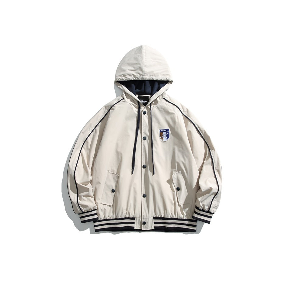 Beige hooded snap-front jacket with navy piping, striped trim and chest shield patch, flat lay