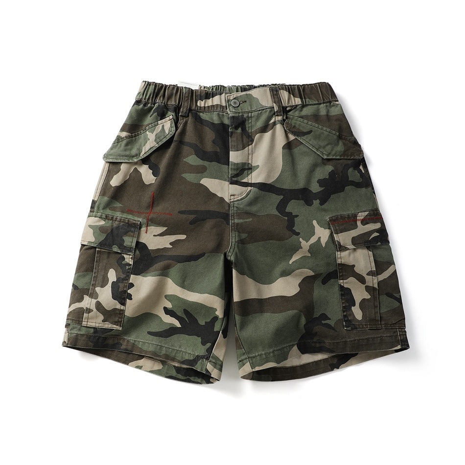 Army green camouflage cargo shorts, front flat lay, with elastic waist, flap pockets and red cross embroidery