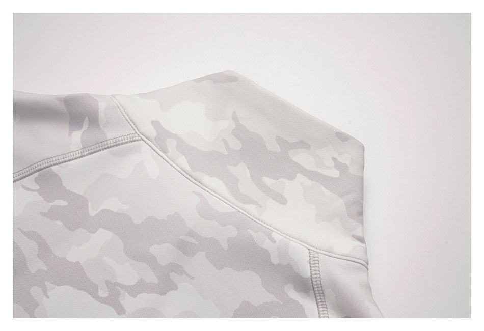 Close-up of a shoulder seam on a pale gray camouflage garment.