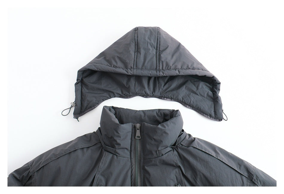 Charcoal gray jacket upper front with its hood displayed separately above the high collar and center zipper.