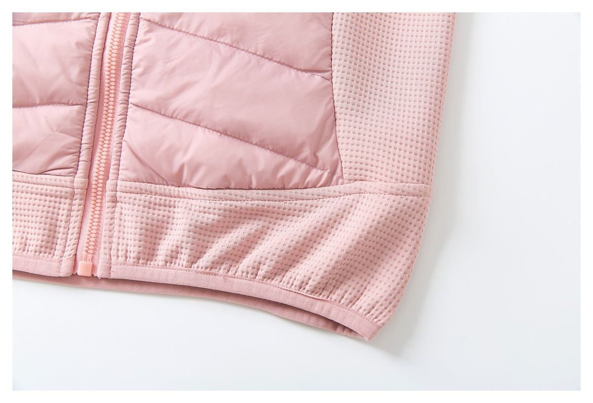 Close-up of the pink jacket's lower front, showing the textured hem panel and front zipper.
