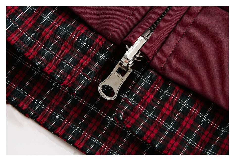 Close-up of the jacket's metal zipper and red, black, and white plaid lining.