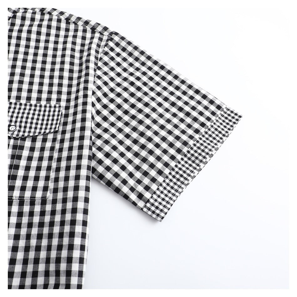 Close-up of a short sleeve on a black-and-white gingham shirt, with a narrow checked cuff trim.