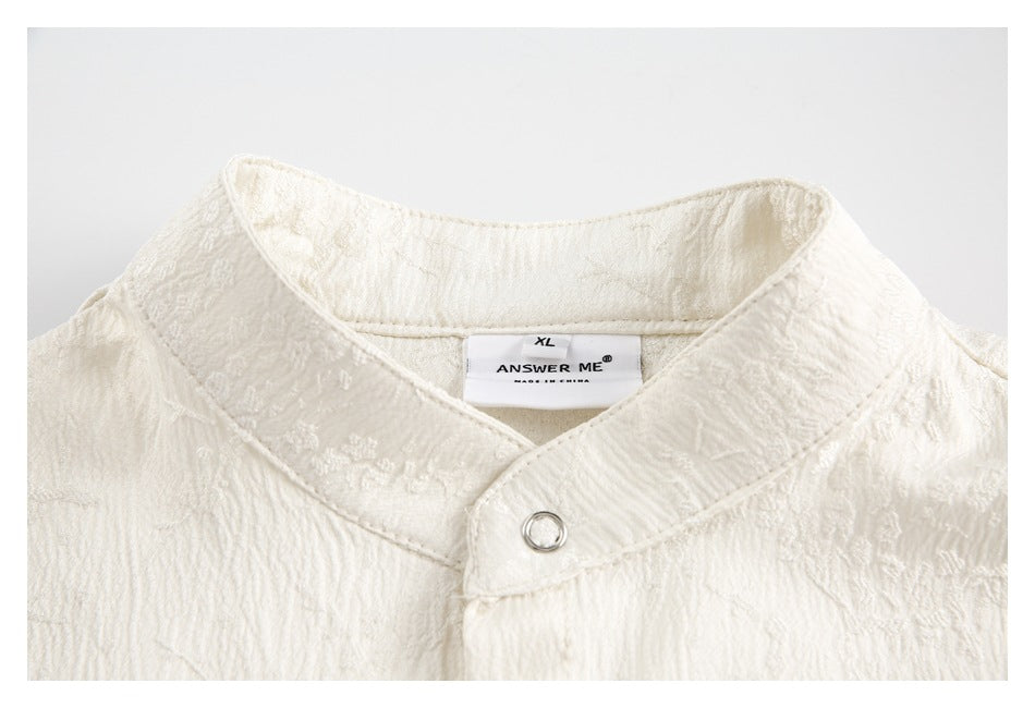 Ivory garment collar with a metal ring closure and a visible sewn-in size and brand label.