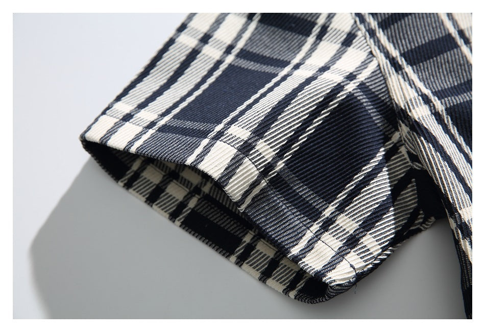 Close-up of the plaid shirt’s short sleeve and finished hem.