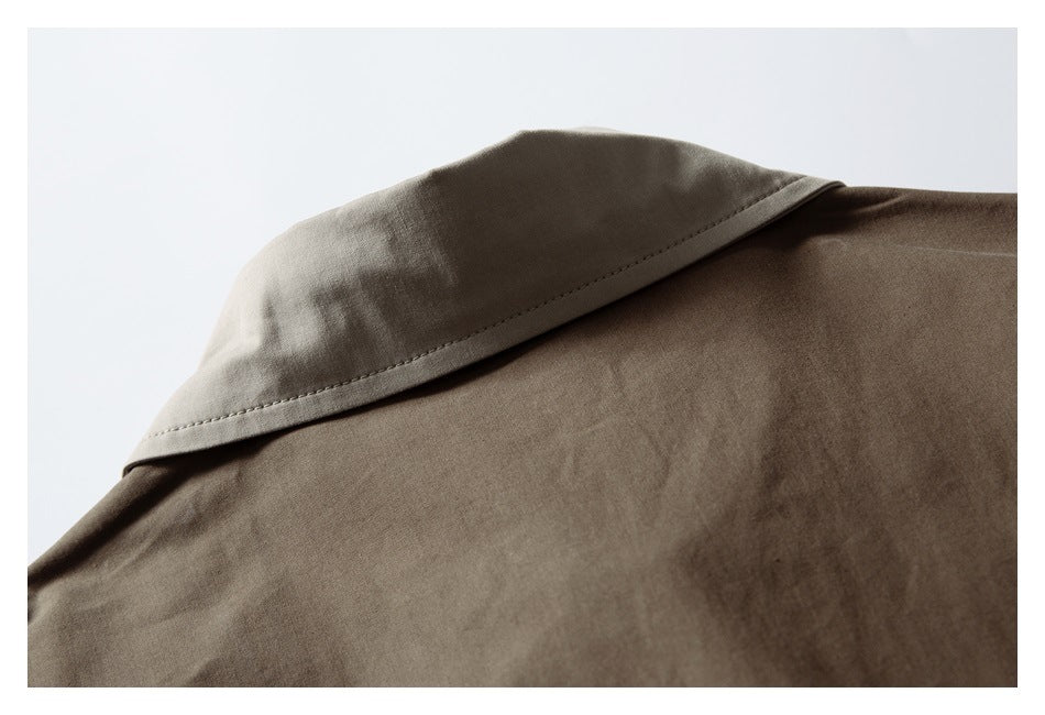 Close-up of a taupe-brown garment collar with visible edge stitching.