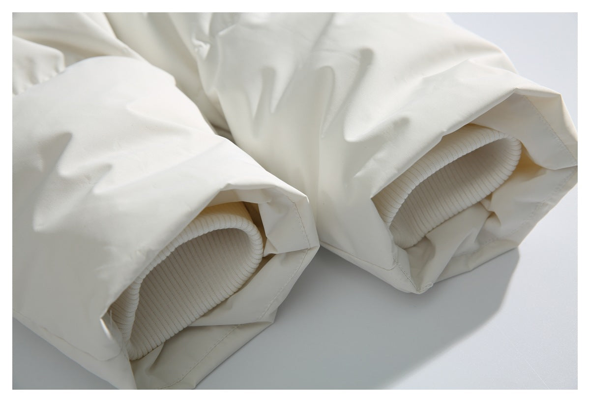 Close-up of the white jacket's sleeve openings with ribbed knit cuffs visible inside.