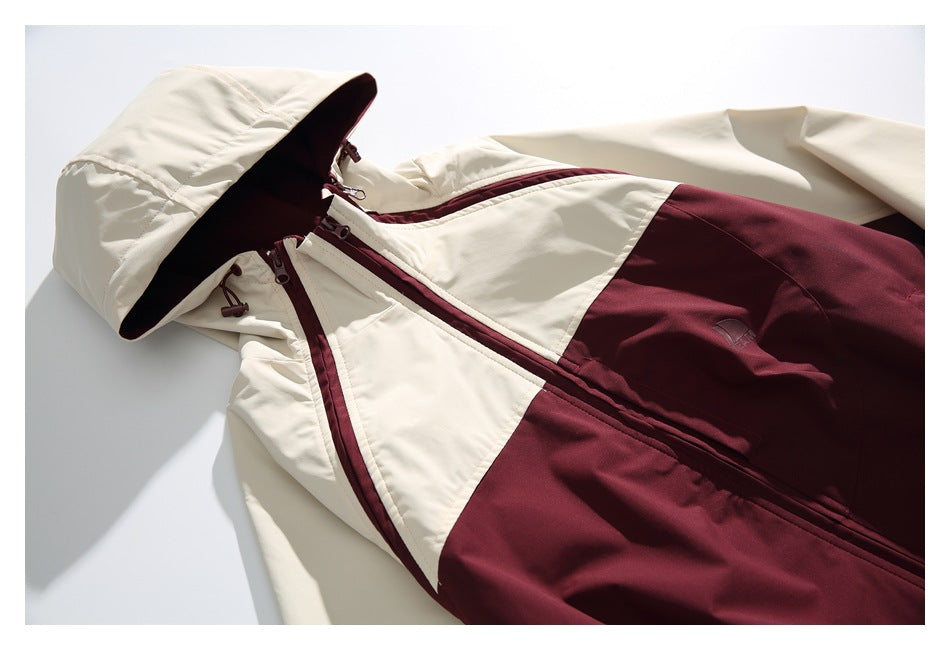 Flat-lay front view of a cream and burgundy color-block hooded jacket with a front zipper.
