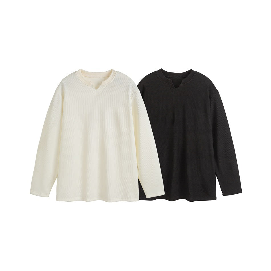 Ivory and black long-sleeve shirts with notched necklines displayed side by side.