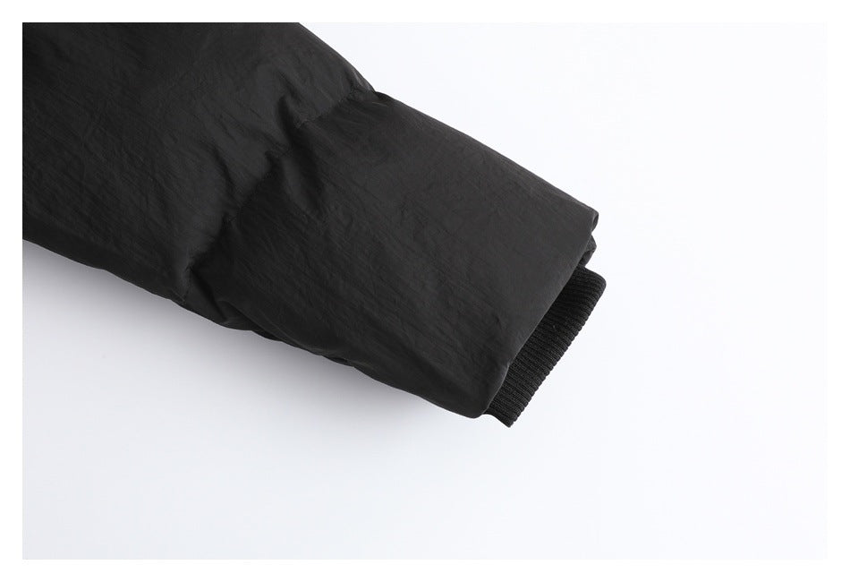 Close-up of the black padded jacket sleeve ending in a ribbed black cuff.