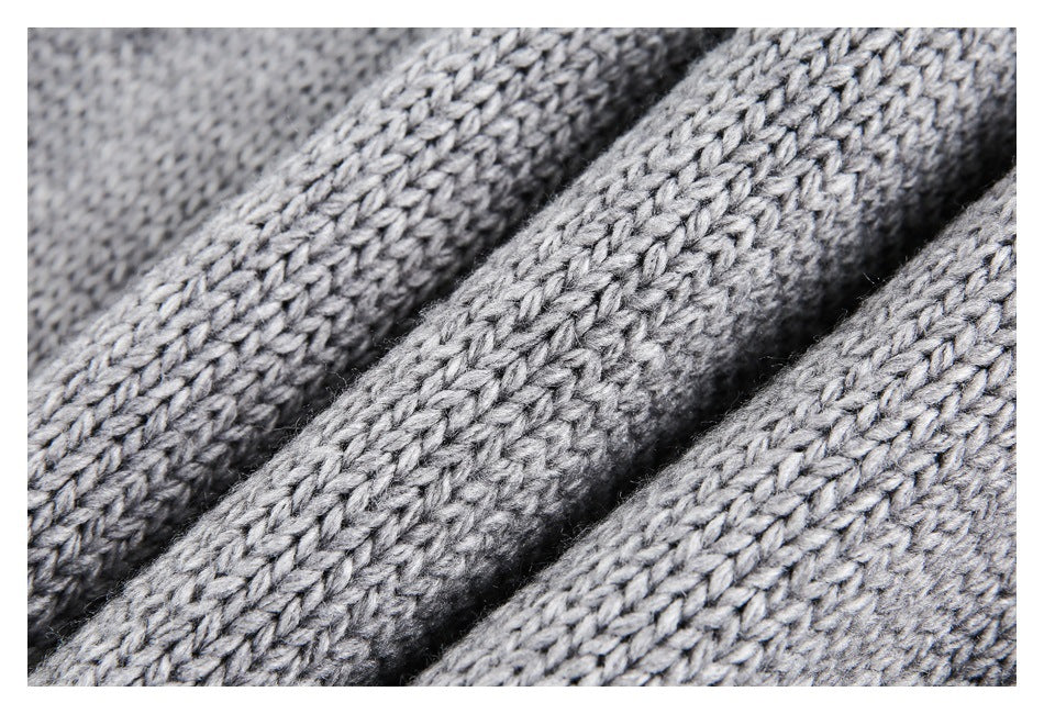 Macro view of gray knit stitches and yarn texture.