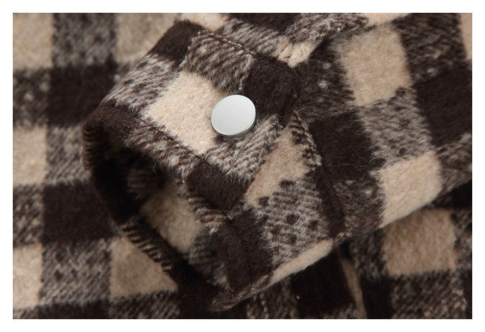 Close-up of a silver snap on the jacket's checked cuff.