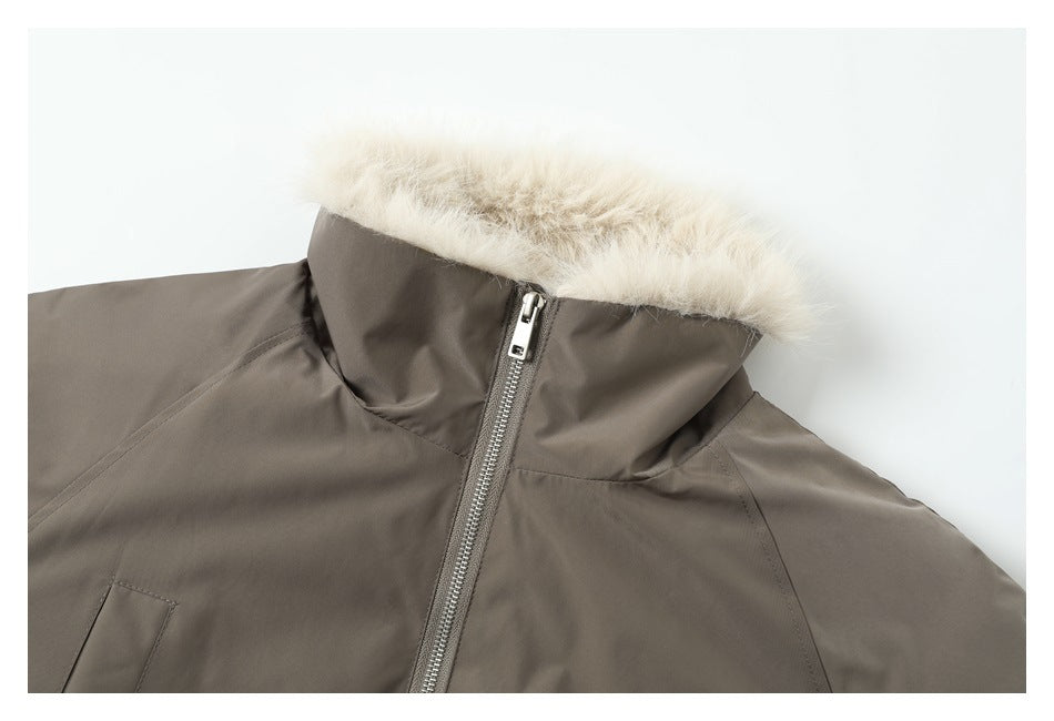 Close-up of a taupe jacket's cream faux-fur collar and metal front zipper.
