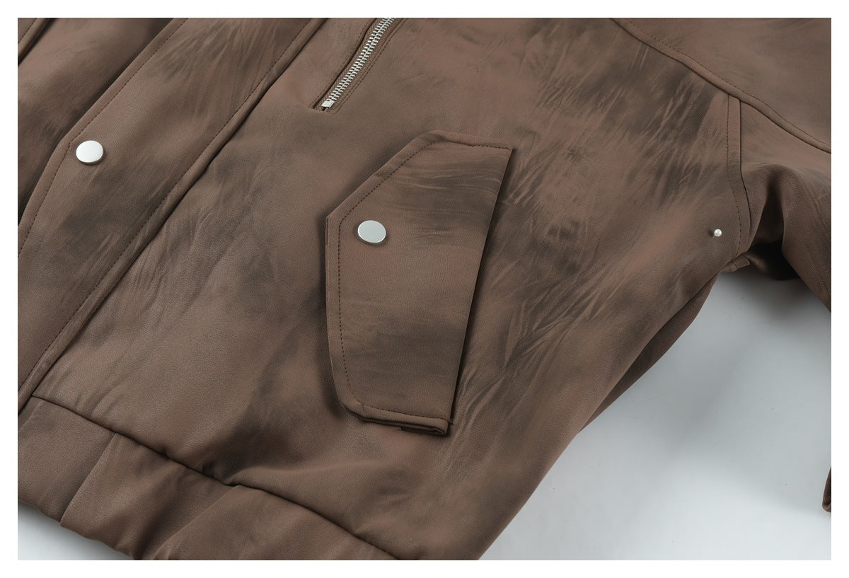 Close-up of a brown jacket's snap-flap pocket, front zipper, and stitched panel details.