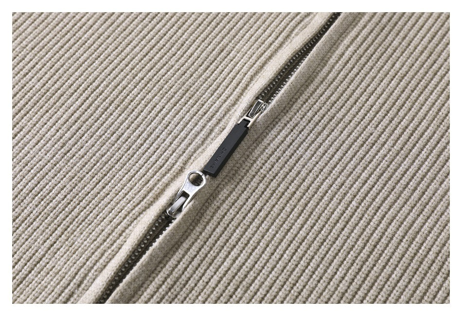 Close-up of the sweater's dark front zipper with a metal slider and pull.