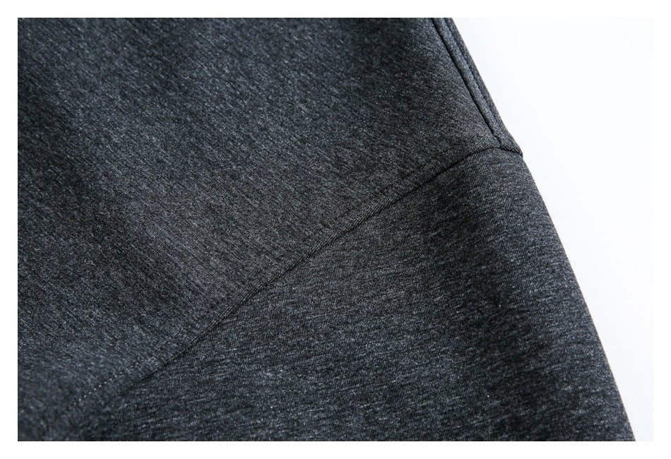 Close-up of a diagonal seam on charcoal heather fabric.