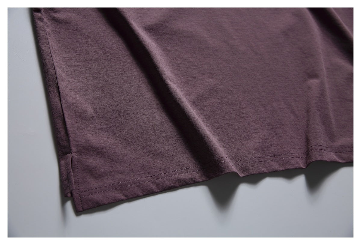 Close-up of the plum T-shirt's straight hem, double stitching, and side seam.