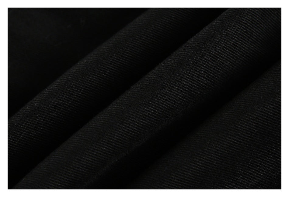 Close-up of black fabric showing a fine diagonal ribbed texture.