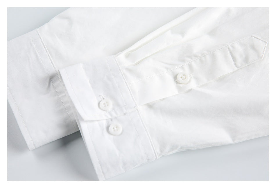 Close-up of a white shirt's buttoned cuff and sleeve placket.