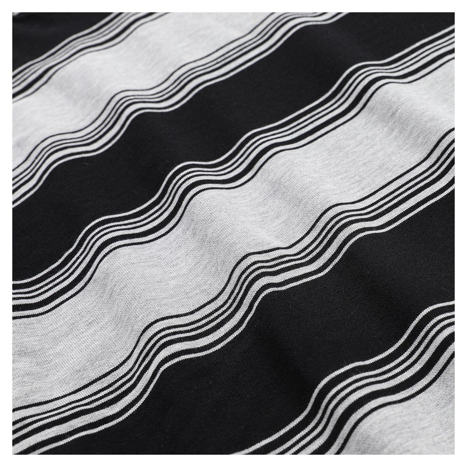 Close-up of black and heather-gray fabric with broad wavy stripes edged by thin parallel lines.