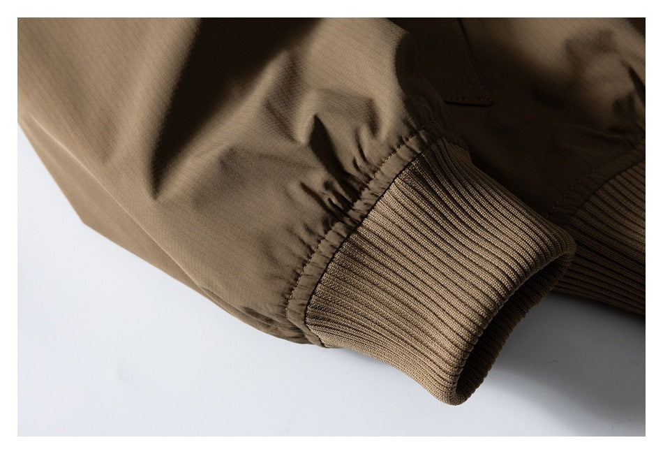 Close-up of the brown jacket's gathered sleeve and wide rib-knit cuff.