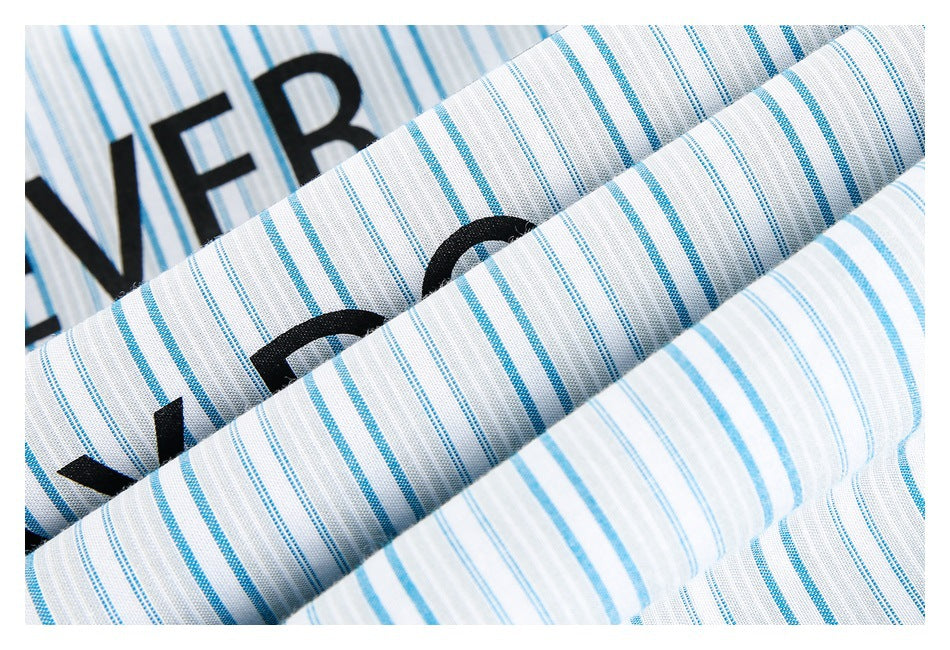 Folded white fabric with blue stripes and partial black lettering in close-up.