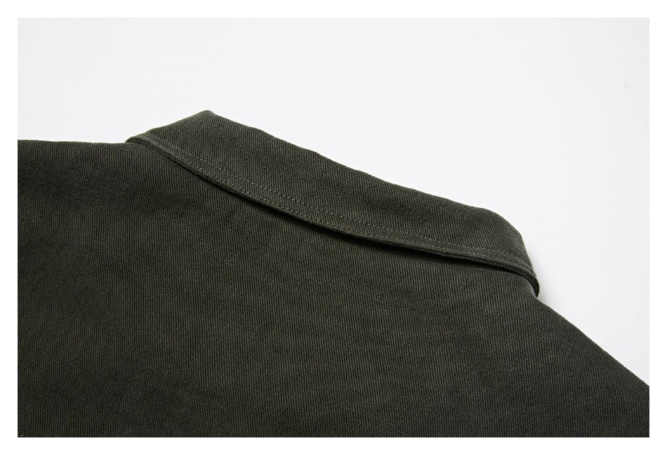 Close-up of a dark olive garment collar and shoulder seam.