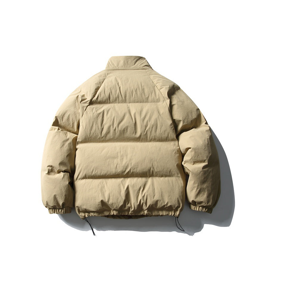 Back view of a light beige padded jacket with horizontal quilting, a high collar, and adjustable hem cords.