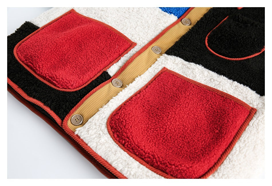 Close-up of a color-block fleece jacket front showing two red patch pockets, a black pocket, and tan button placket.