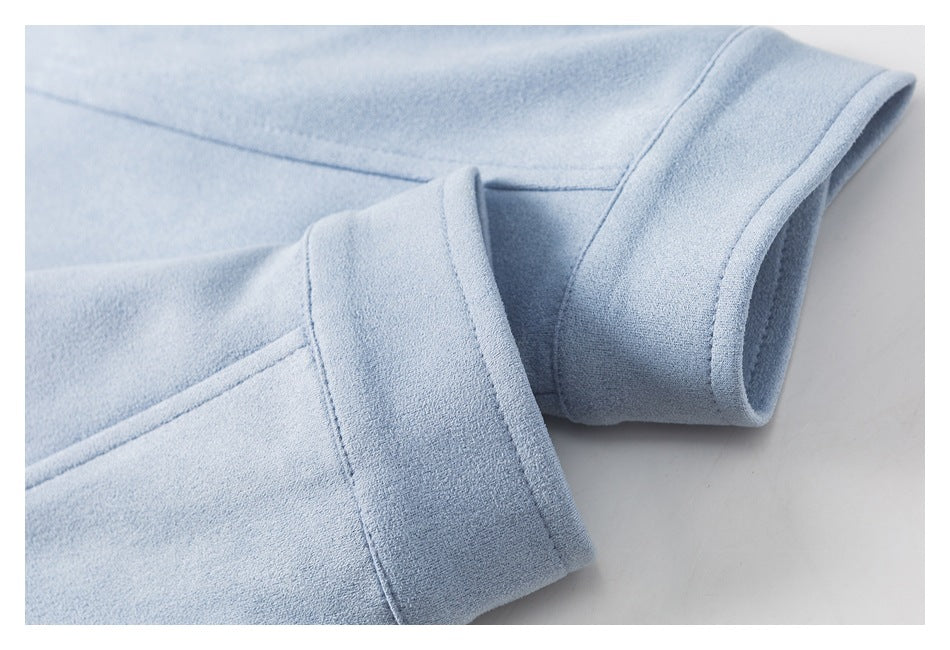 Close-up of a pale blue garment sleeve ending in a wide folded cuff.