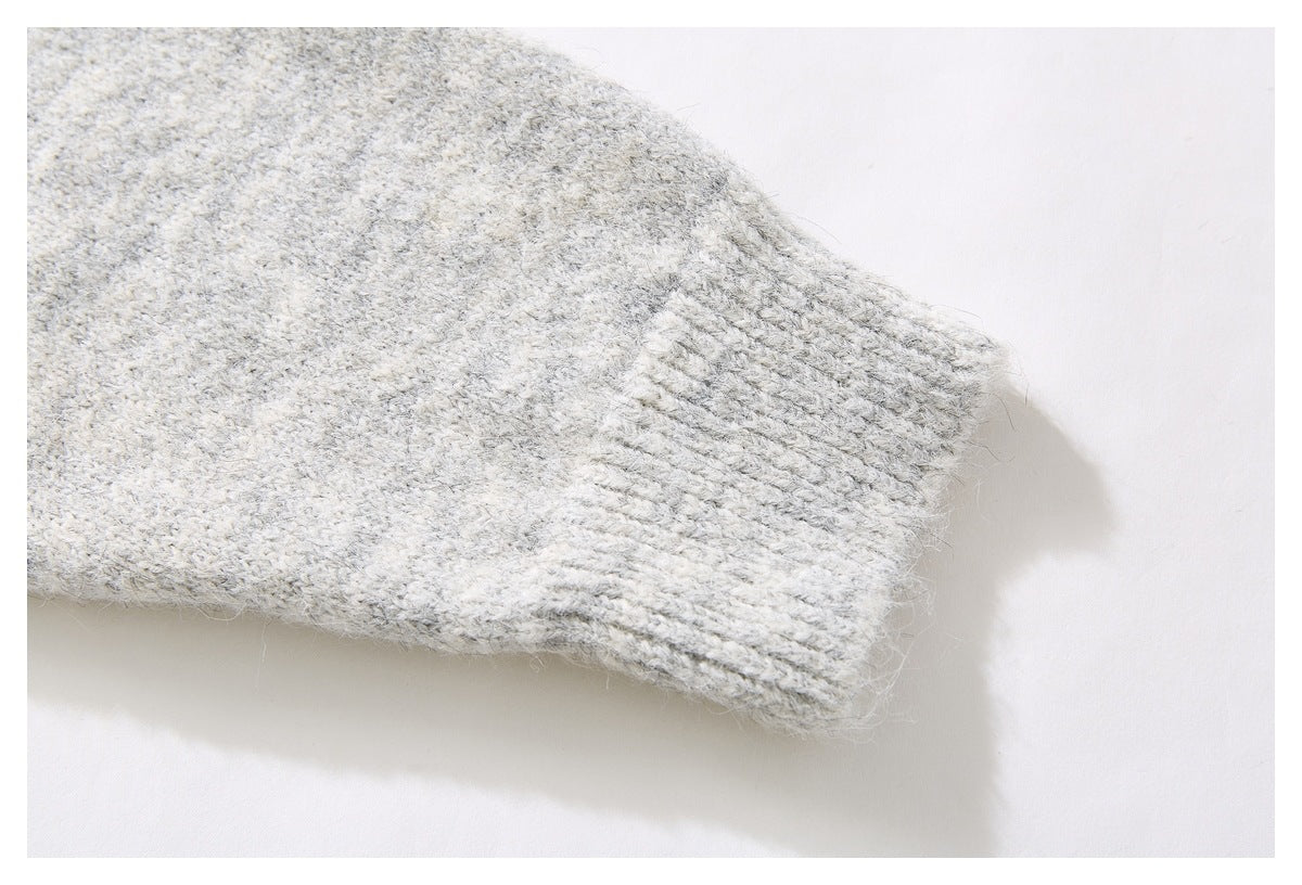 Close-up of a ribbed cuff on the light gray marled knit sweater.