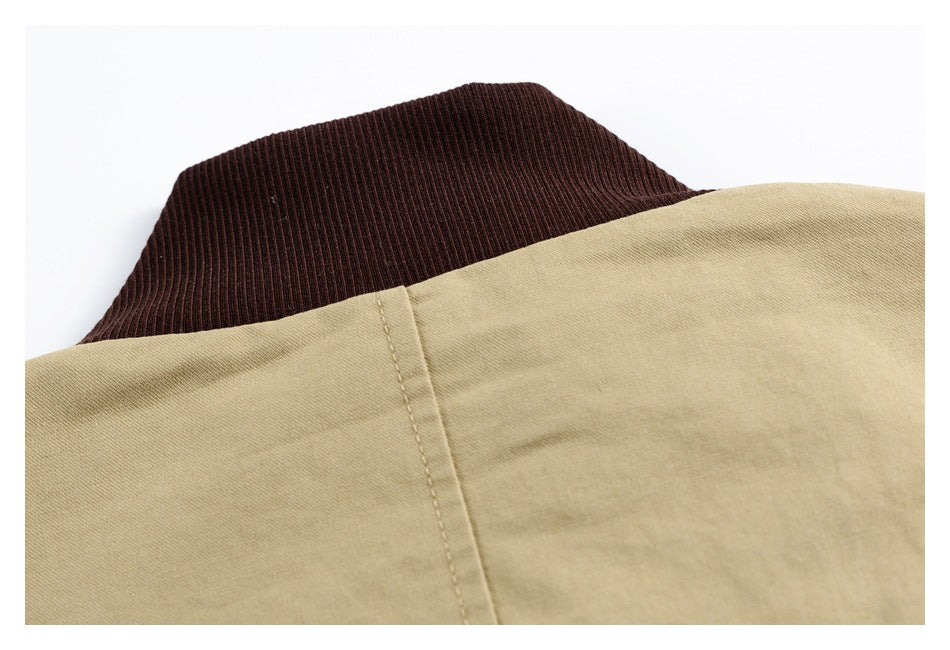 Close-up of a dark brown ribbed collar against beige garment fabric.
