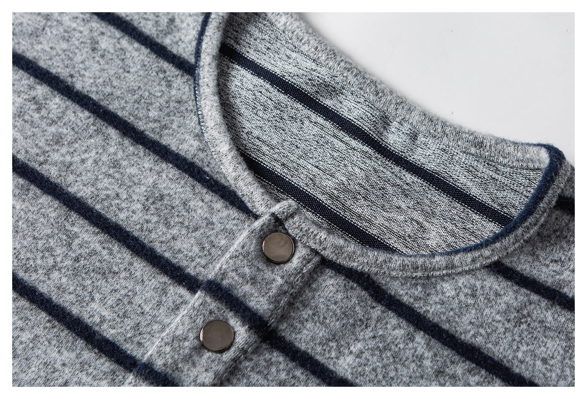Close-up of the shirt's striped crew neckline and button placket with two dark buttons visible.