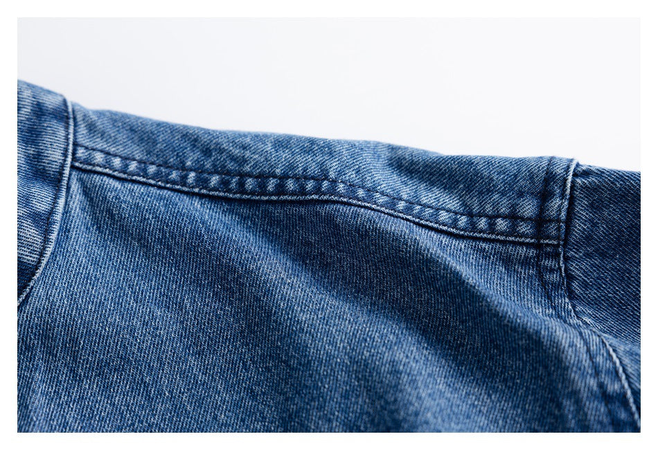 Close-up of a curved double-stitched seam across blue denim.