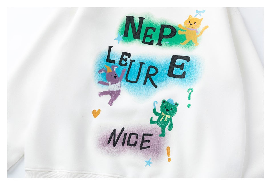 Close-up of a white sweatshirt with colorful animal illustrations and bold black lettering on the front.