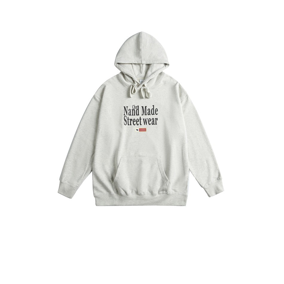 Light gray pullover hoodie with drawstrings, front pouch pocket, and black Nand Made Street wear chest print, flat lay