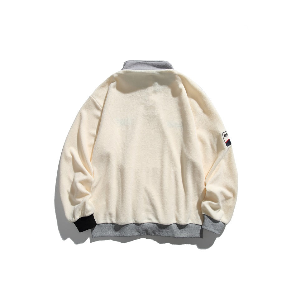 Back view of an ivory pullover with a gray collar and hem, contrasting sleeve cuffs and a small sleeve patch.