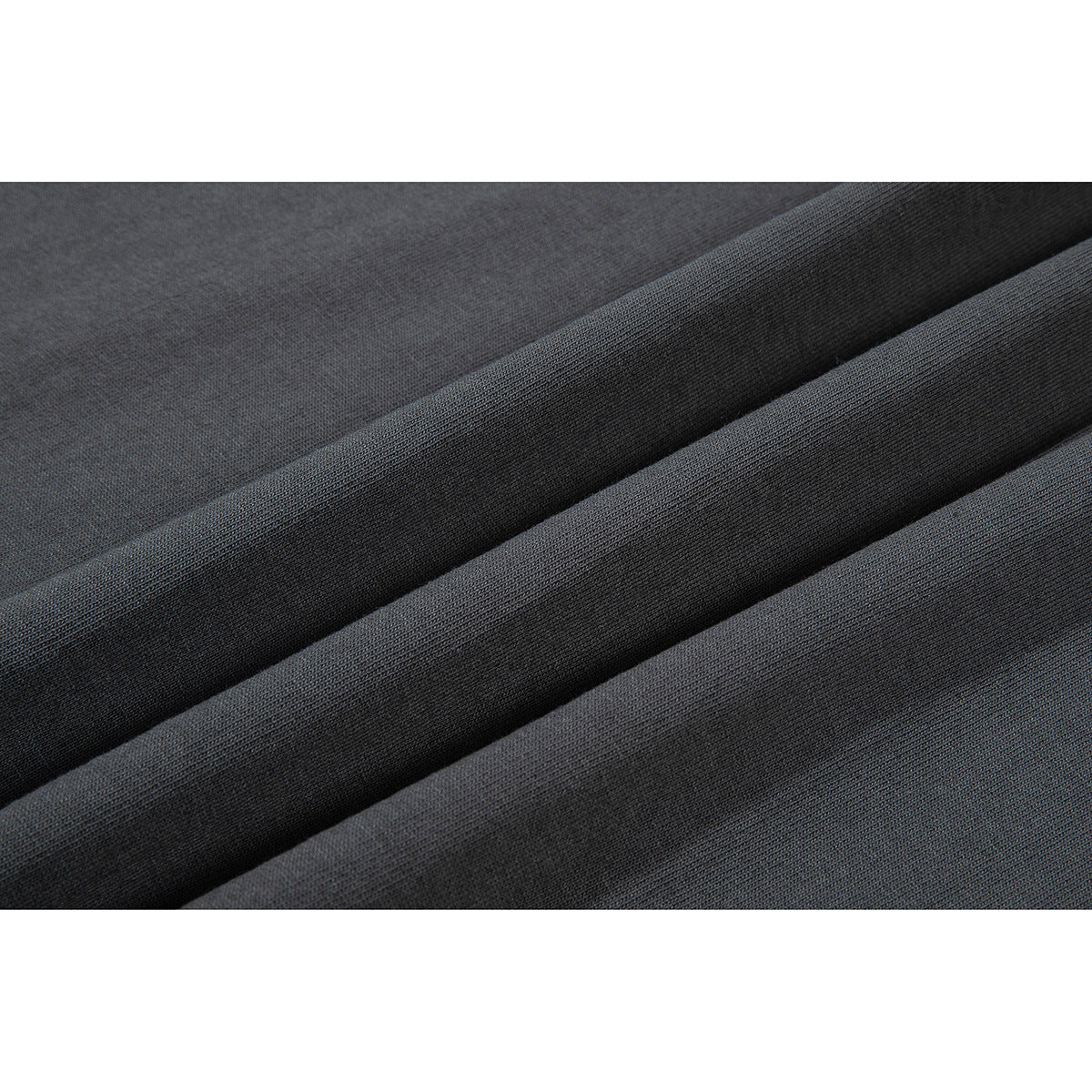 Close-up of charcoal fabric draped in folds, showing its fine surface texture.
