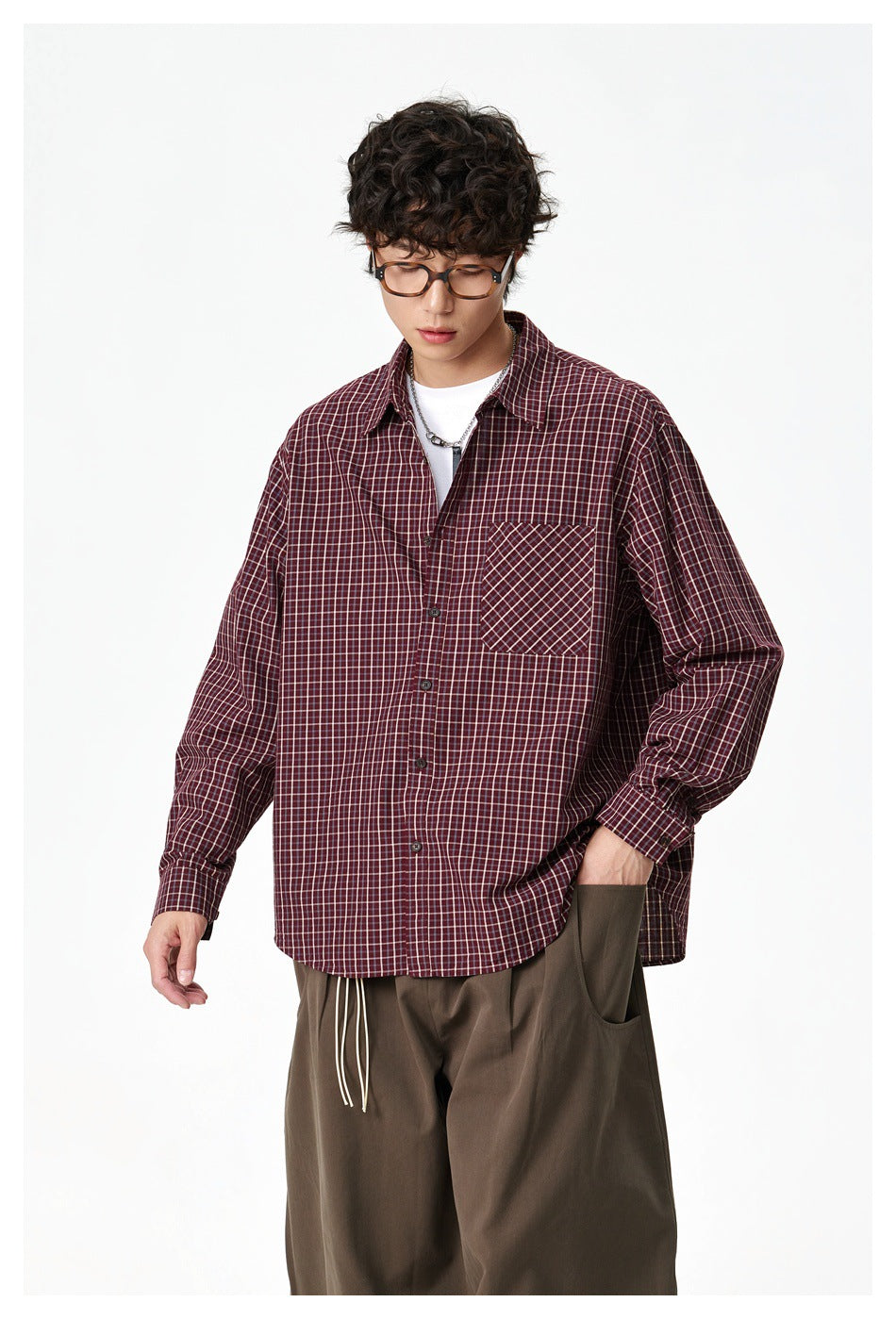 Model wearing a burgundy check button-up shirt with a contrasting diagonal-check chest pocket.